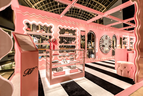 Pink-themed luxury retail pop-up with elegant displays.